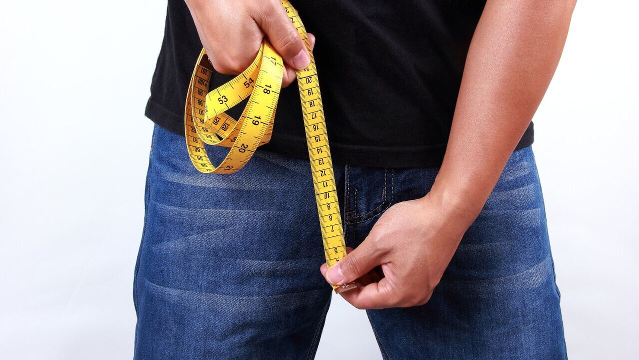 Man measuring penis before enlargement