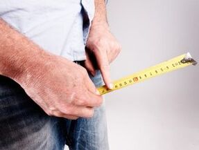 a man measures the length of his penis before soda augmentation